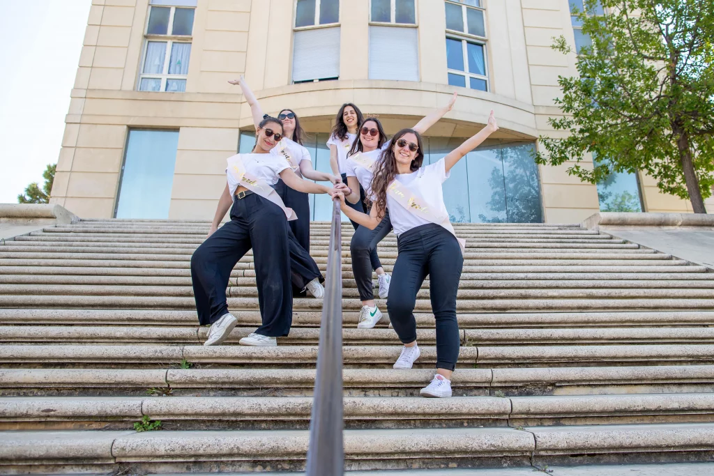 Photographe spécialisé en shooting photo EVJF, photo prise à Montpellier à Rive du Lez. les filles sont sur un escalier et prennent la pose devant l'objectif