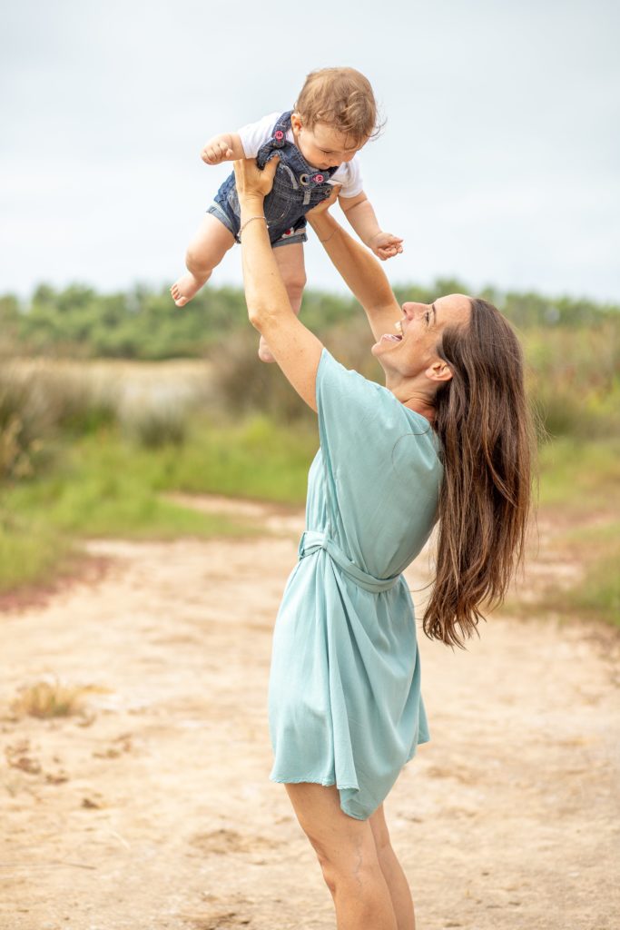 photographe, shooting et séance photo famille, maman qui jete en l'air son bébé et qui rit aux éclats tout les deux